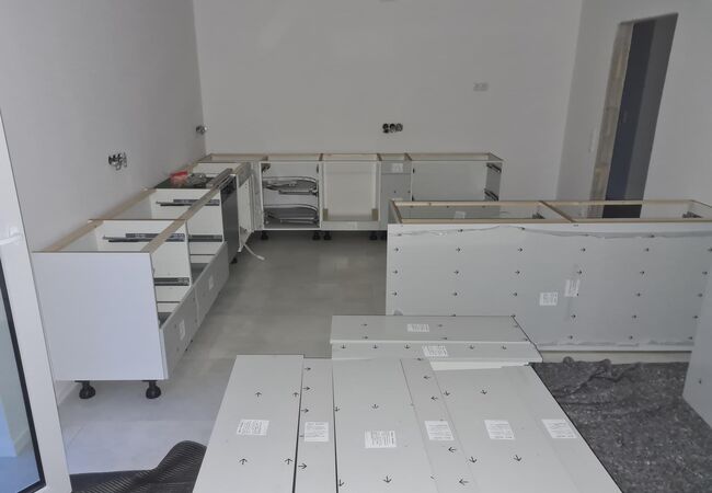 Aufbau einer neuen Küche - Teile der aufgebauten Unterschränke, weißer Korpus